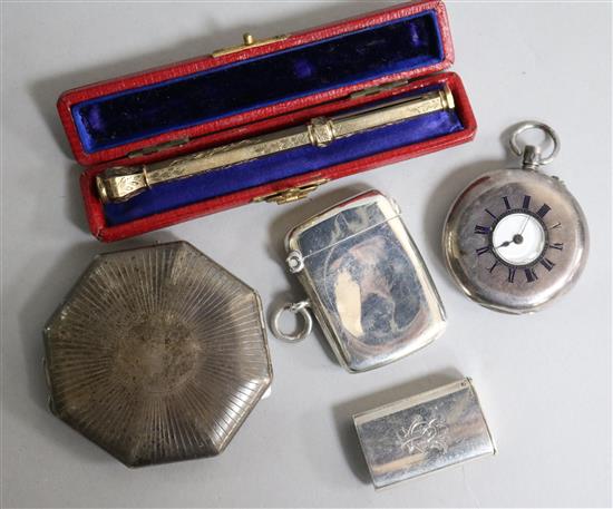 Two silver vesta cases, a silver cased travelling timepiece, a silver fob watch and a gold overlaid propelling pencil.